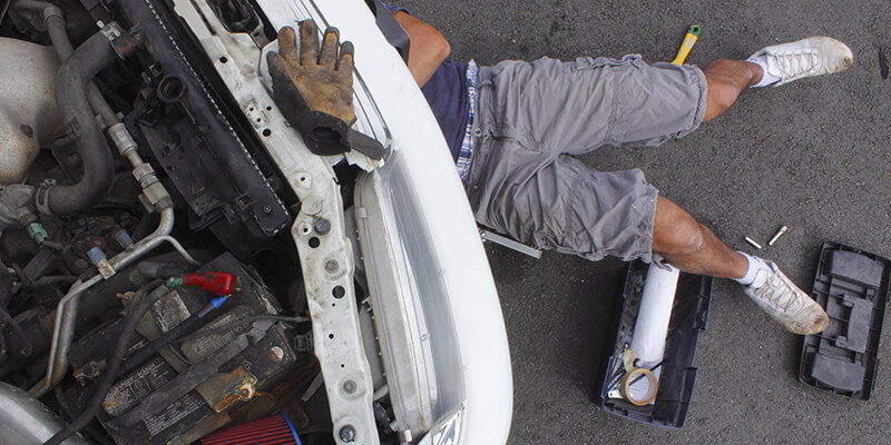 Man looking under car