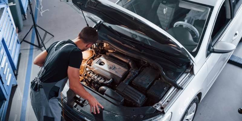 Mechanic Looking Under Bonnet